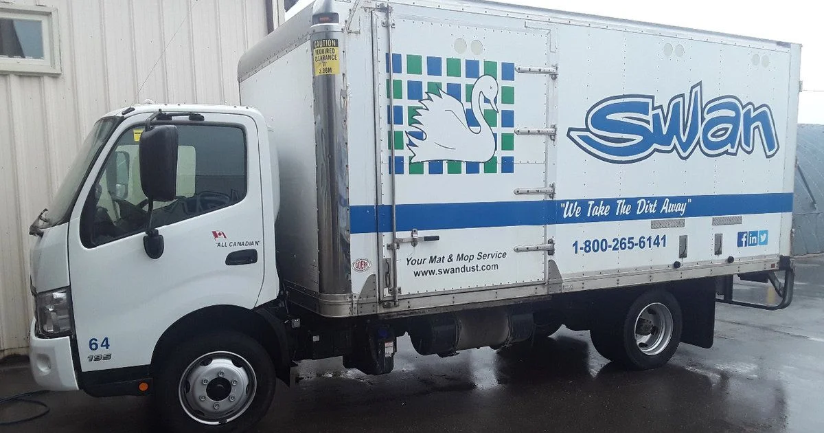 Swan Dust Control service truck parked outside facility